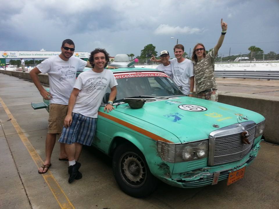 Ted Fort along with the rest of his racing team, Idle Chatter, poses next to the old diesel Mercedes that won within its class in a race in Sebring last July. 
