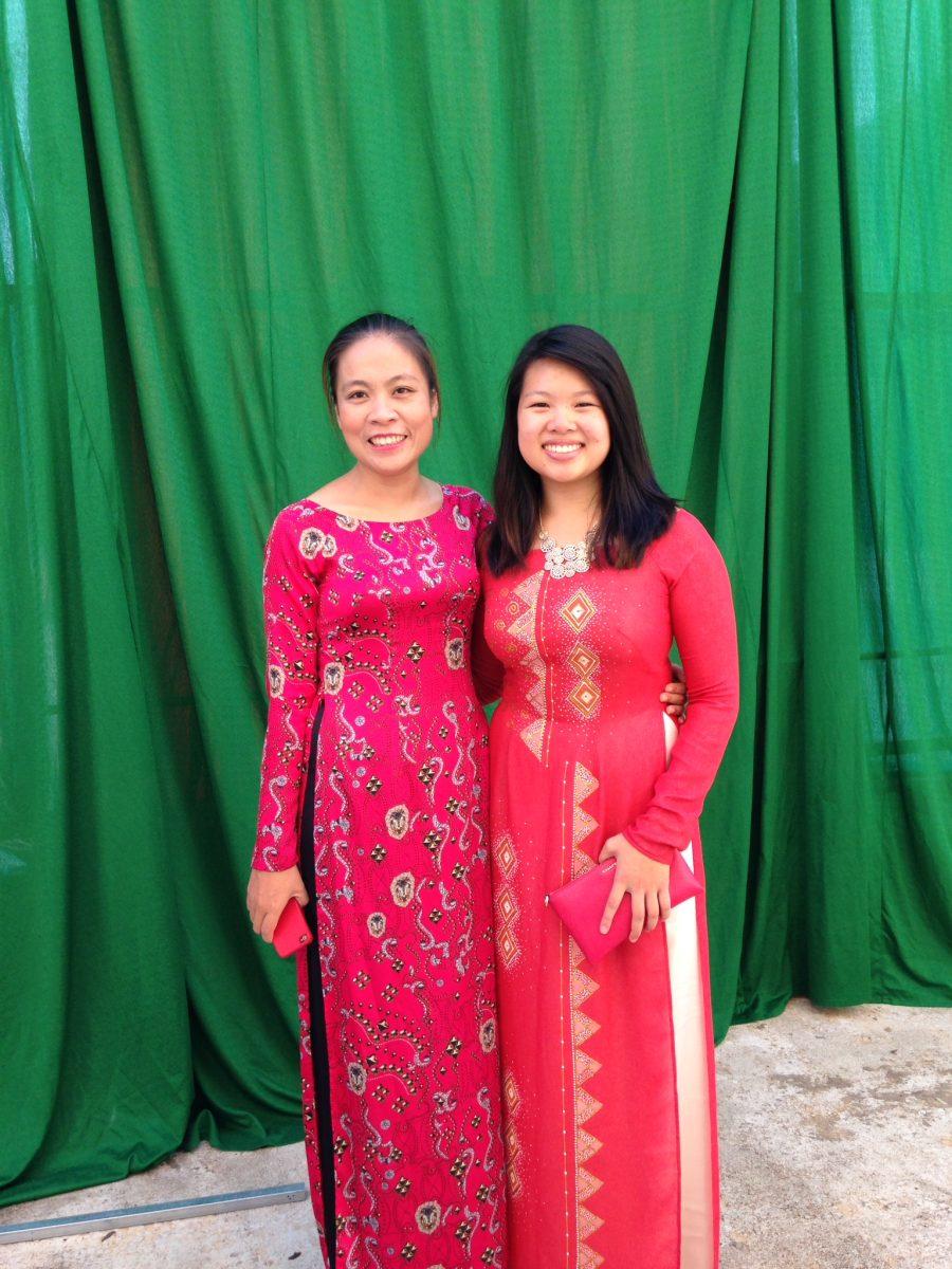 Le with a coworker on Opening School ceremony day. Both are wearing a traditional Vietnamese dress called ao dai.