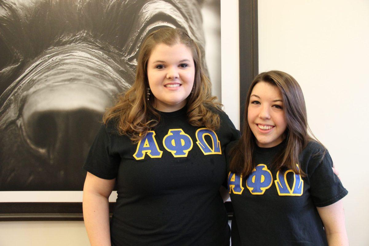 Sydney Allsbrook (left) and Angela Ditolla (right) share their experiences in Alpha Phi Omega to promote Alpha Phi Omega’s rush week.
