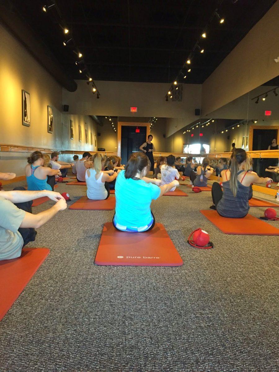 Students studying exercise fads for Interim hit the mats for an ab workout at their Tuesday Pure Barre class.
