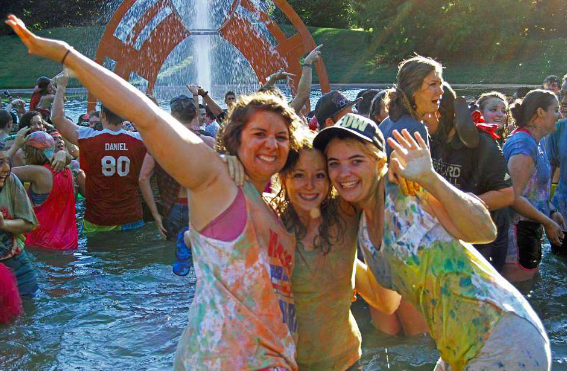 Students jump in the fountain after Fountain Fest in the fall of 2013 as part of a student tradition.