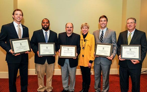 “There’s not a lot of discrepancy between the three inductees,” says Athletic Director Richard Johnson. “All of these players warrant induction.”  Pictured from left to right: Brandon Waring, “Heavy” Anthony Jones, Mr. and Mrs. Wade Keesler, Nick Schuermann and Todd Shanesy. Photo courtesy of Mark Olencki. 