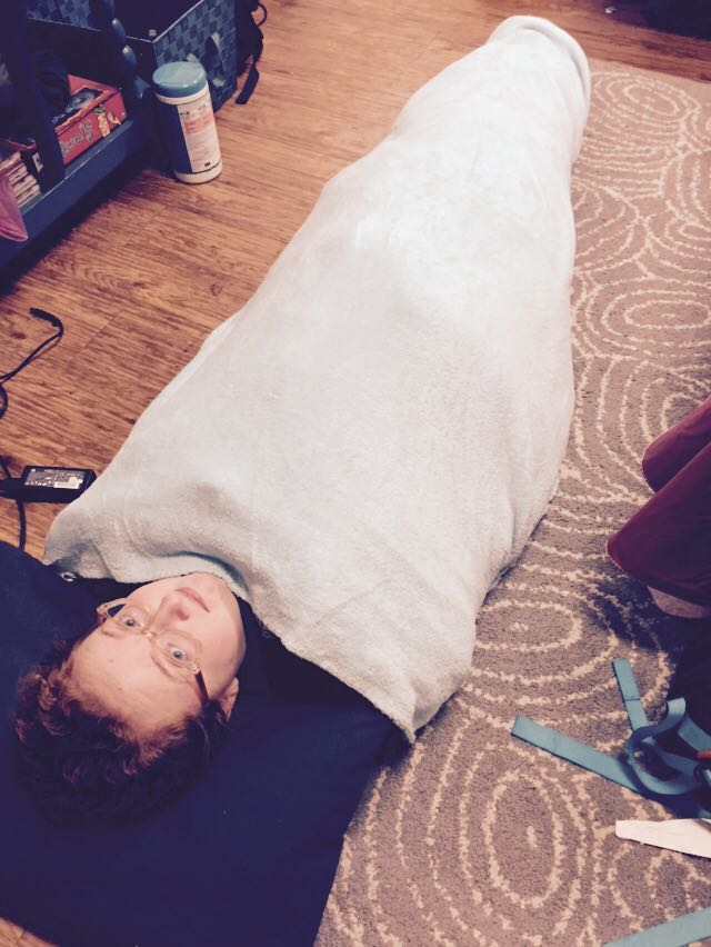 “Instead of working on my capstone and paper, I laid on the floor for three hours,” says Aubrey Knight, ’16, demonstrating the burrito method.