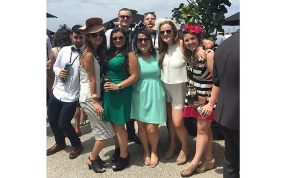 Brie White (center) and Caroline Moseley (far right) pose with friends made while studying abroad at the Melbourne Cup Horse Races. 