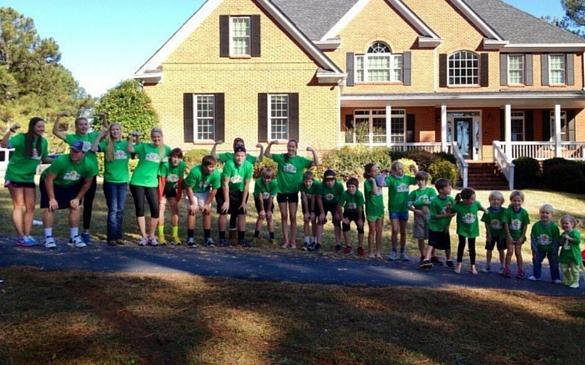 Sarah Madden and her 22 other cousins pose in matching shirts after running their annual Turkey Trot family race the morning of Thanksgiving.