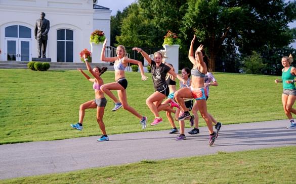 Sarah Spiro ’18, middle, and other members of the women’s cross country team goof off for the camera on their way back from a workout. Photo by Mark Olencki.