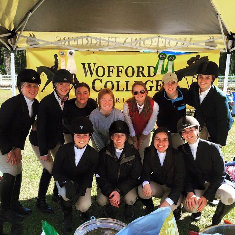 Wofford riders gather after the first few classes of the day to celebrate their new banner, given by the Andrews family.