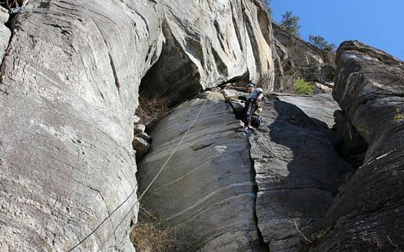 Dr. Ben Cartwright laybacks a crack climb during an outdoor climbing trip.