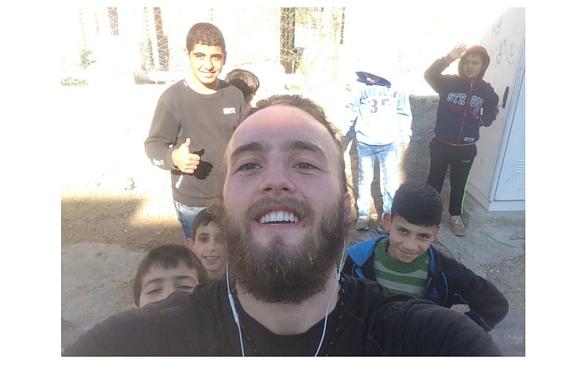 Nicholson snaps a selfie with the group of boys he met on the street while on a run. Every Friday after prayers, kids will throw rocks at the wall separating Israel and Palestine, until the Israeli army begins throwing teargas to stop them.