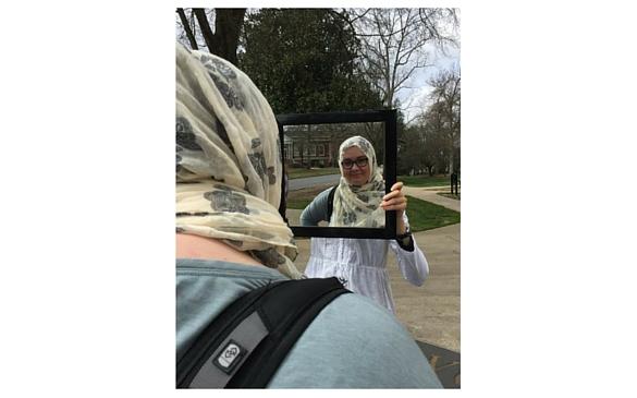 McKenzie Blanton tries on a hijab for “In Her Shoes: Experience the Hijab,” an event hosted by the Muslim Student Association for Women’s History Month. Photo courtesy of Anum Ahmed.