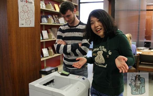 Senior Tayler Tot and freshman Queen Zee wait at one of the malfunctioning printers in the library. They claimed that they had been waiting for 20 minutes. Left to right: Tot and Zee. (Photo courtesy of Louis Shyman)  