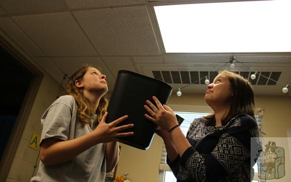 Two students use their repurposed trashcan-turned-water-bucket to pray to the rain gods (Lion King style), asking for a break in the tumultuous weather.