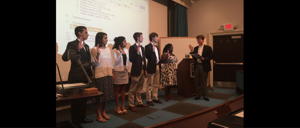 Rod McCants 17, chair of the judicial commission, swears in the six new delegates. Photo by Abbey Brasington.