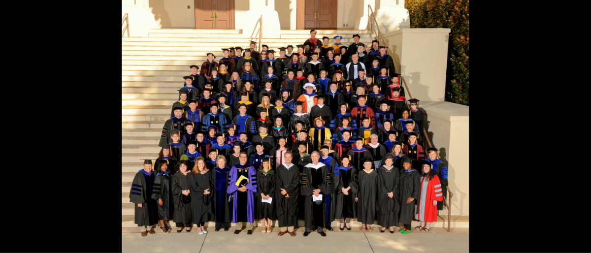 Professors pose on stairs of Old Main after this year’s opening convocation.