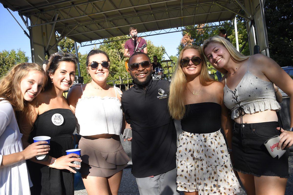 Wofford students pause from celebrating and listening to recording artist Joe Lasher at the Sept. 21 tailgate to smile for a picture
