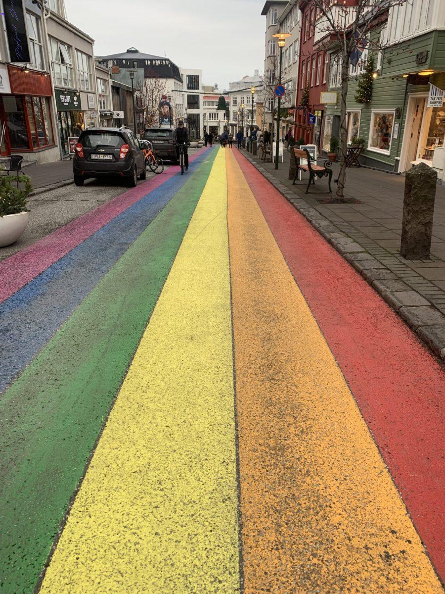 A road painted with the Gay Pride flag