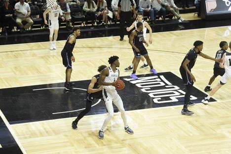 Wofford Forward Chevez Goodwin dribbles the ball against a Furman defender