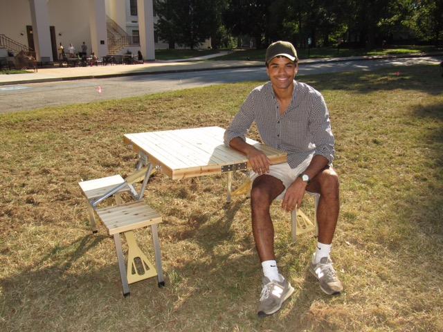 Jordan Willey ‘23 sits at one of the portable picnic tables.