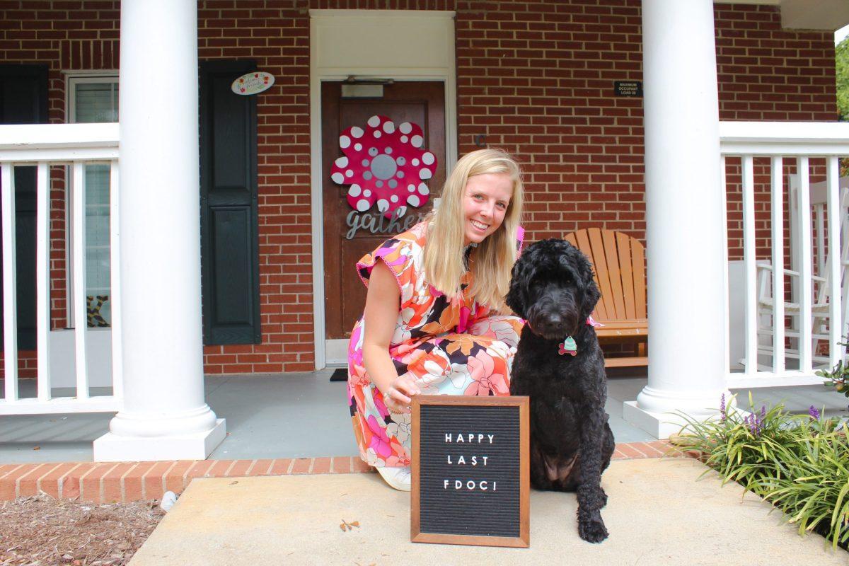 Virginia Cook ‘21 and her dog, Kit, pose for the first day of school in September.