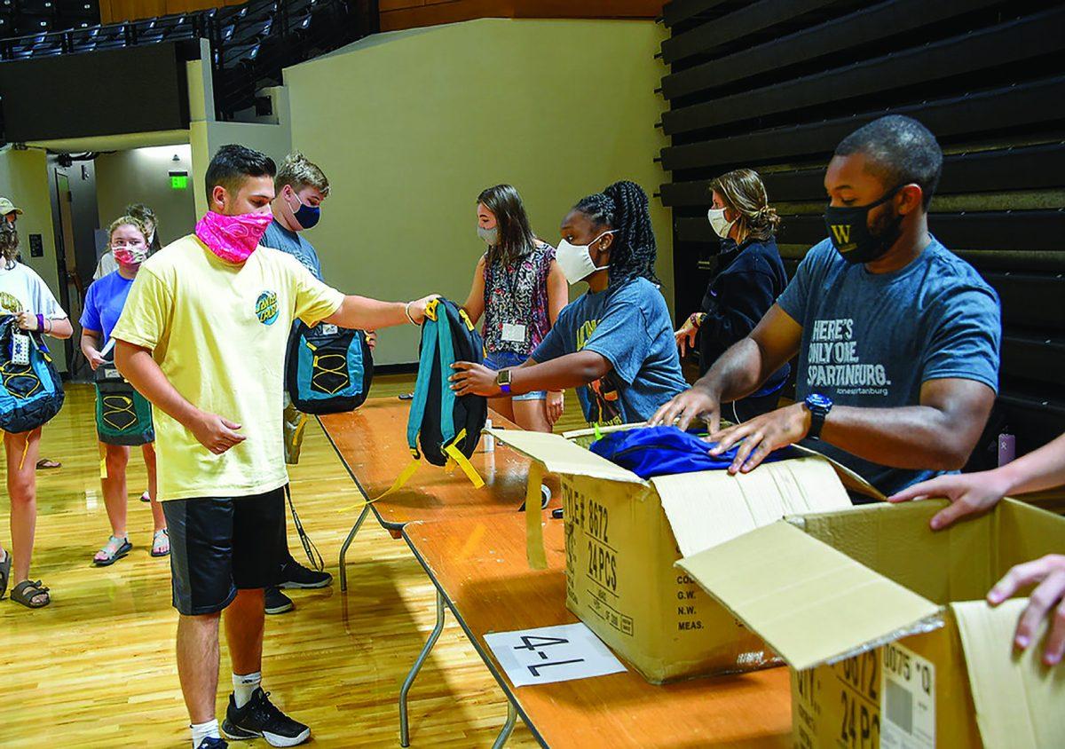 Freshman students during the Fall 2020 Orientation service project filling backpacks with school supplies for underprivileged students, photo by Mark Olencki.
