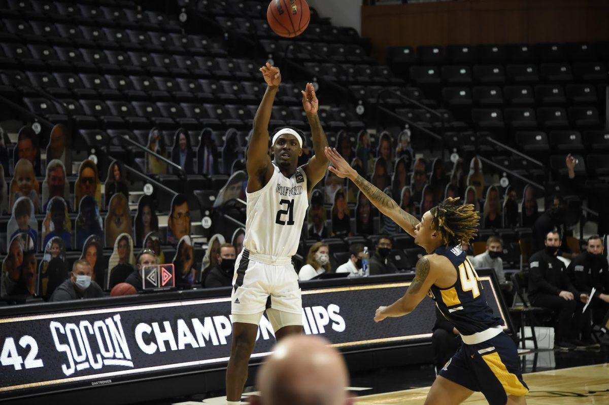 Wofford Guard Tray Hollowell ‘21 (#21) rises up for a jump shot against UNCG. The Terriers came up short, falling 84-75. Photo courtesy of Mark Olencki.