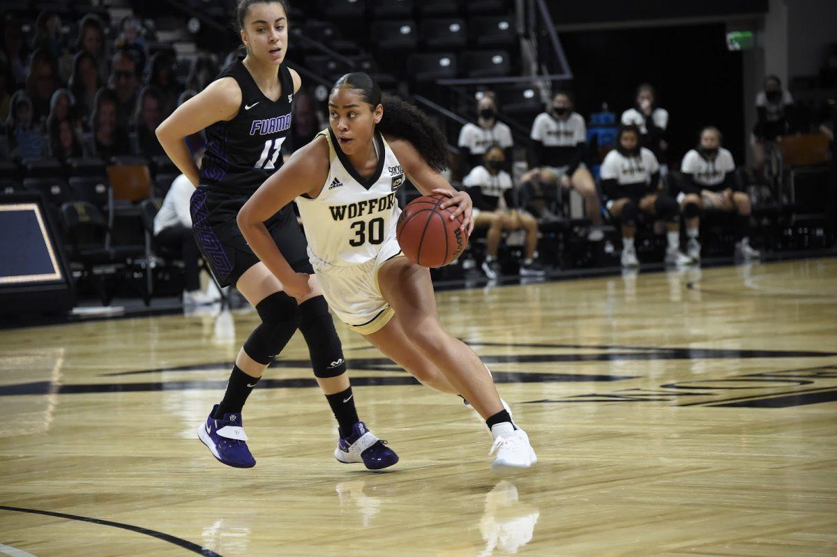 Wofford guard Jackie Carman ‘22 (#30) drives against a Furman defender. The Terriers went on to win 61-54. Photo courtesy of Mark Olencki.