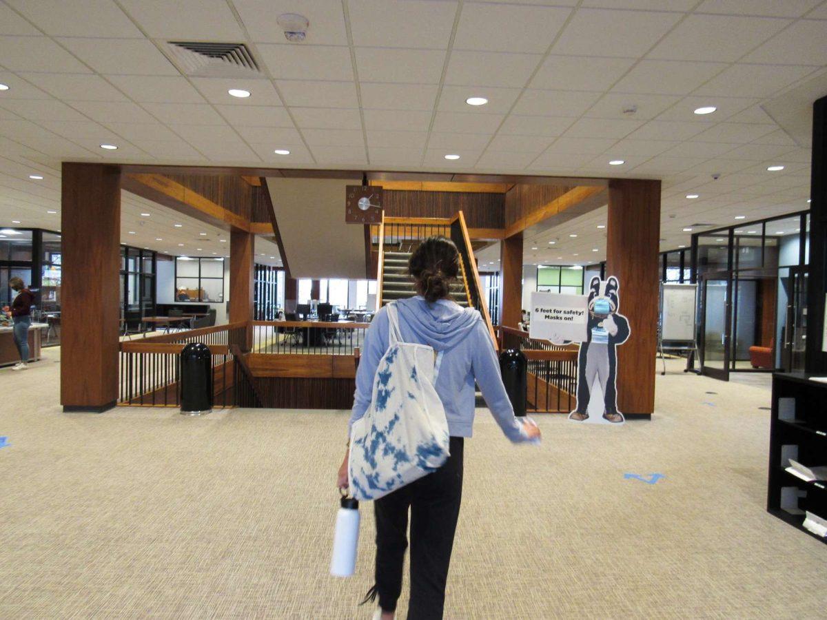 A student walks into the library full of books. The mold outbreak that occurred last semester has been resolved, which means students and faculty will soon have access to the library’s physical collection again. Photo courtesy of  Natalie Aversano.