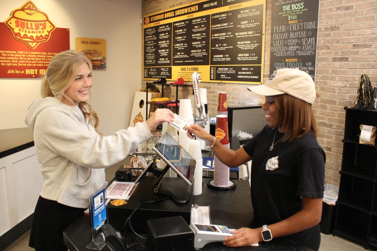 Millie Hatchette ‘26 hands her Wofford ID card to Messiah Moring ‘25 to purchase food from Sully’s Steamers. Sully’s Steamers now accepts Wofford Terrier Bucks.
