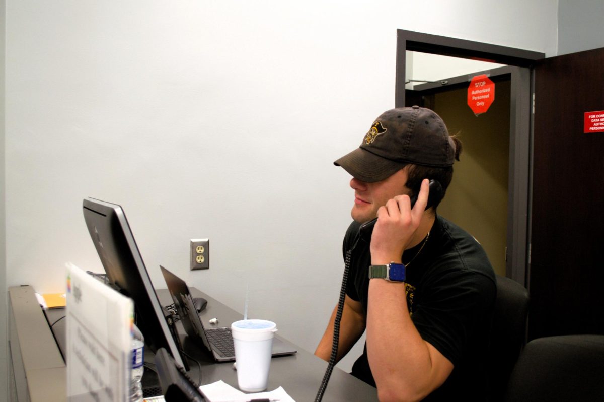Joey Kimberling ‘25 takes a call on his shift working at the IT Department. 
The IT Department works to make students’ lives easier, helping solve problems with computers, WiFi, and TV signals. 