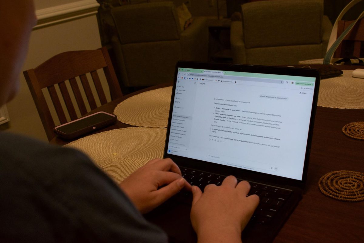 Lillian Smith ‘26, pictured working in her Senior Village apartment, uses AI as a study tool to prepare for upcoming exams.