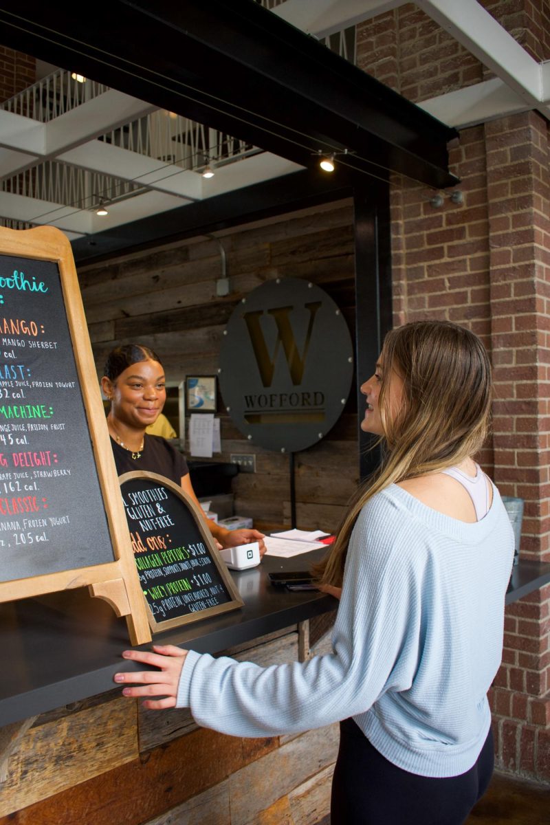 Caris Mitchell ‘27 serves a student during the soft launch of Studio Smoothie. Mitchell’s entrepreneurship is expanding fresh fruit options on Wofford’s campus.