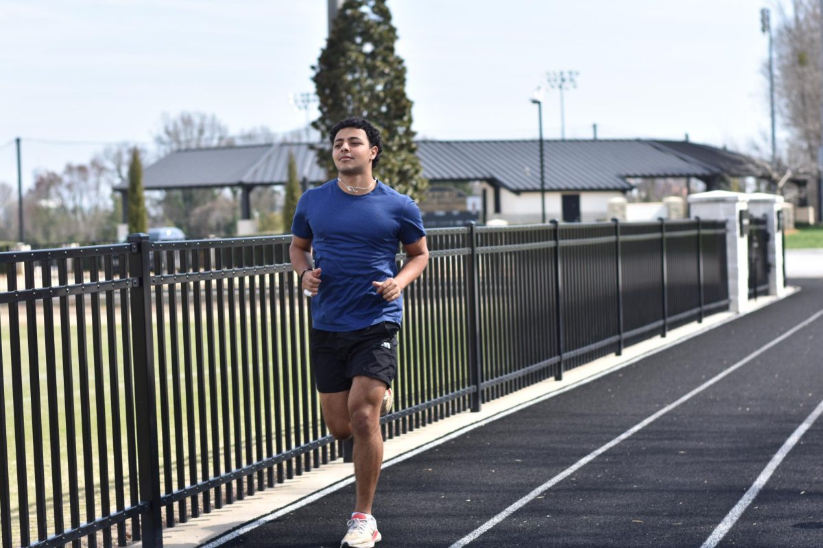Joe Khalil ‘26 warms up for his long run on Wofford’s walking track. His fundraising event, Go With Joe, is coming up next month